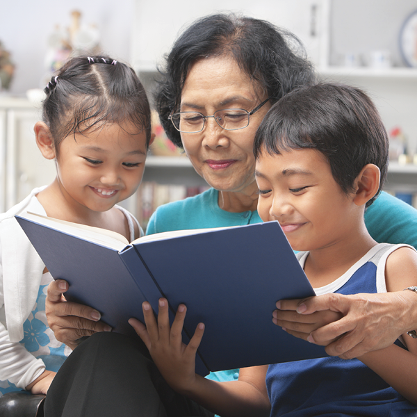 Image of grandparent reading to children