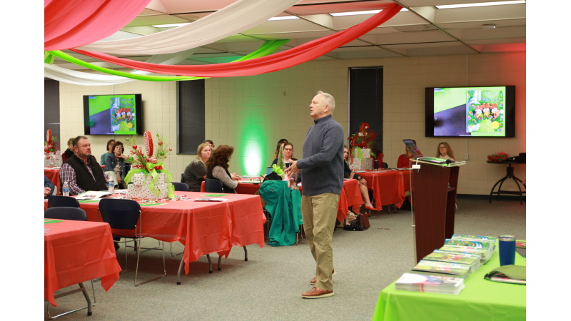 Author Lester Laminack speaks to a crowd about the new reading program.